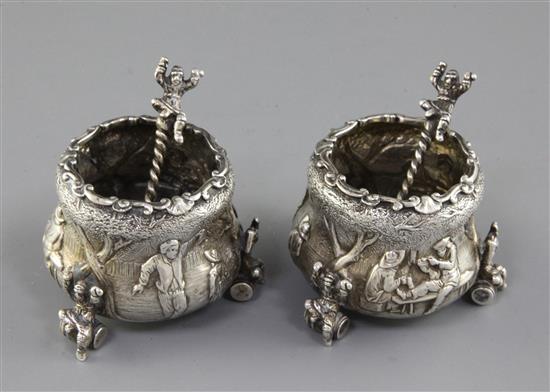 An ornate pair of Victorian silver tub shaped salts and spoons by F.B. Thomas & Co, height 1.75in.